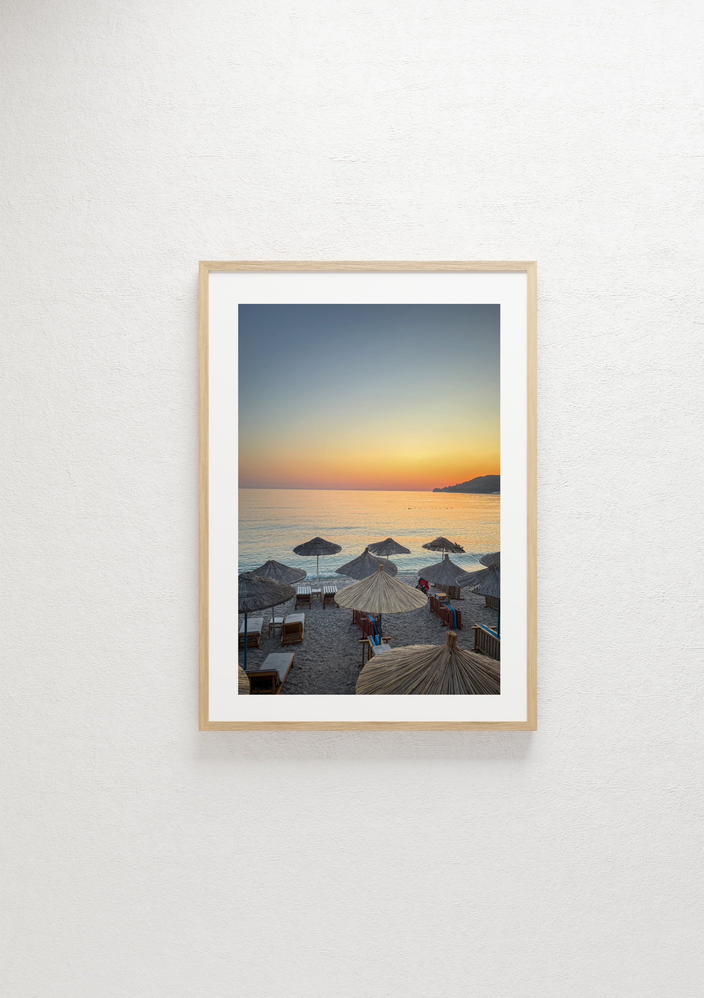 Straw beach umbrellas at dusk in Himare, Albania – photographic wall art print