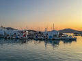 Marina with boats at sunset, mountains in the background