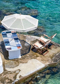 Taverna table at the water's edge in Mandrakia, Milos – photographic wall art print